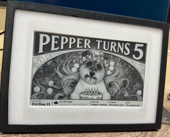 A real Moonpress frame on a desk showing a picture titled Pepper Turns 5